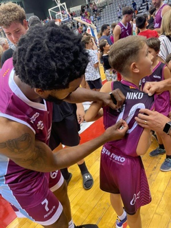 Donovan Saine signing autograph for a child